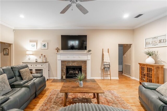 10164 Waterford Way, Mobile, AL 36695 - living room with ceiling fan, ornamental molding, light wood-style flooring, a stone fireplace, and recessed lighting