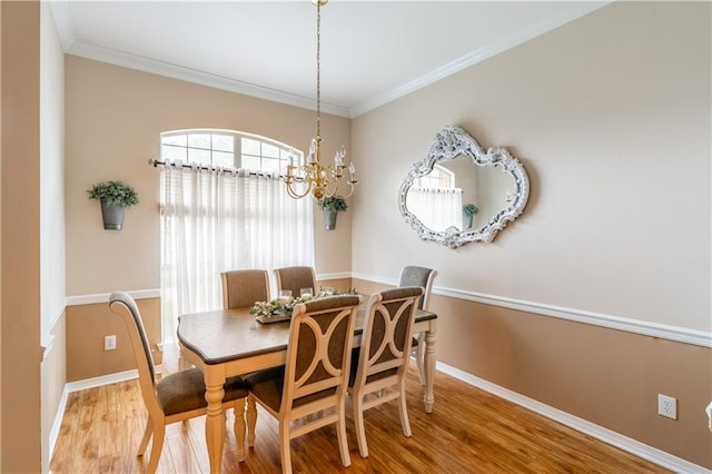 10164 Waterford Way, Mobile, AL 36695 - dining space featuring wood finished floors, a chandelier, and crown molding
