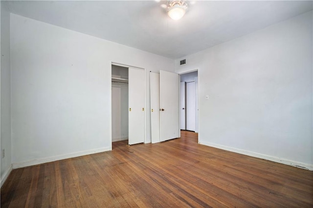 2852 Exter Dr, Mobile, AL 36606 - unfurnished bedroom featuring wood finished floors, a closet, and baseboards
