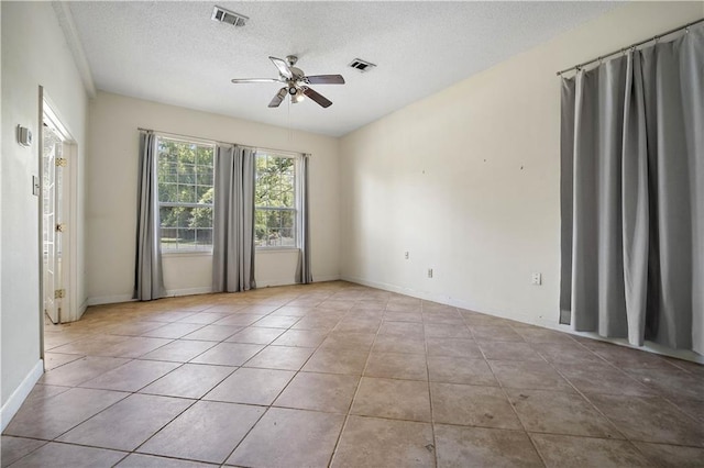2852 Exter Dr, Mobile, AL 36606 - spare room featuring ceiling fan, a textured ceiling, tile patterned flooring, and baseboards