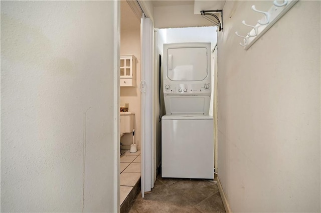 2852 Exter Dr, Mobile, AL 36606 - laundry room featuring stacked washer / dryer and tile patterned flooring
