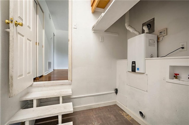 2852 Exter Dr, Mobile, AL 36606 - laundry room with tankless water heater, dark wood-type flooring, washer hookup, and baseboards