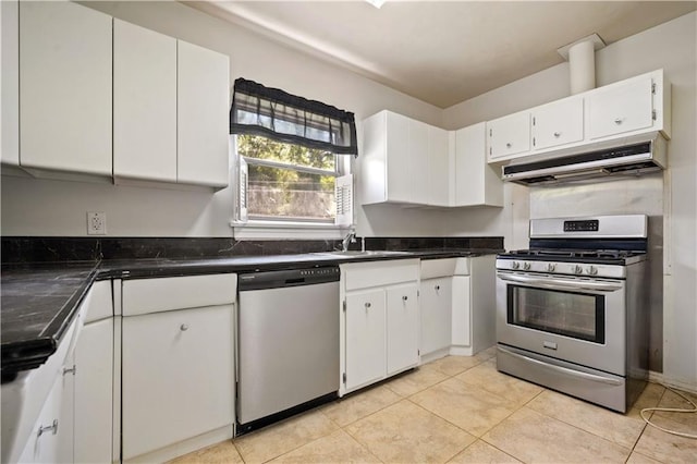 2852 Exter Dr, Mobile, AL 36606 - kitchen featuring stainless steel appliances, under cabinet range hood, white cabinetry, dark countertops, and light tile patterned floors