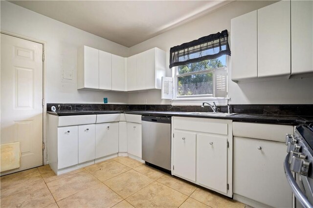 2852 Exter Dr, Mobile, AL 36606 - kitchen featuring stainless steel appliances, a sink, dark countertops, white cabinets, and light tile patterned floors