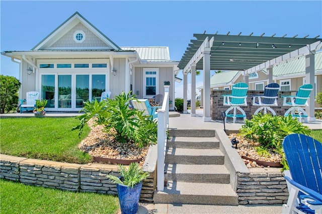 exterior space featuring a front lawn and a pergola