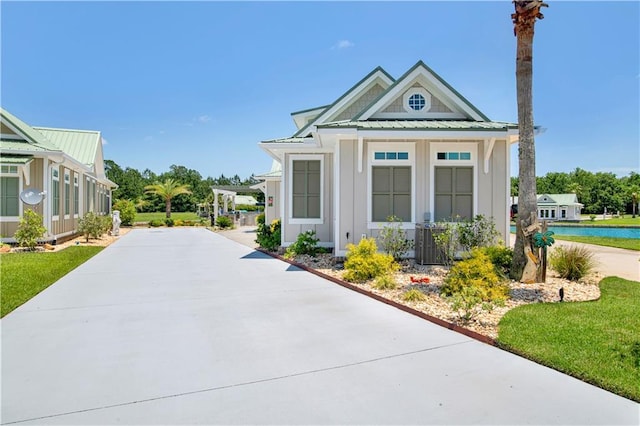 exterior space featuring a water view, central AC, and a front yard