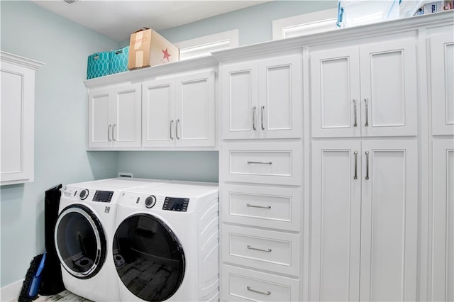 laundry area featuring cabinets and washing machine and clothes dryer