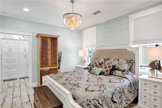bedroom featuring crown molding, a chandelier, and multiple windows