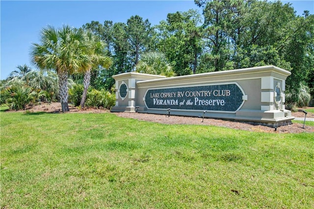 community sign featuring a lawn