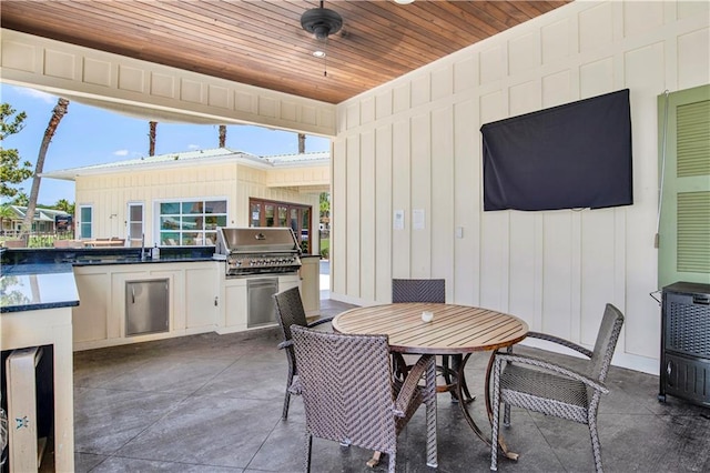 view of patio / terrace featuring an outdoor kitchen, ceiling fan, sink, and area for grilling