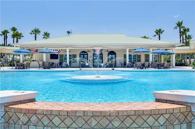 view of swimming pool featuring a patio and ceiling fan