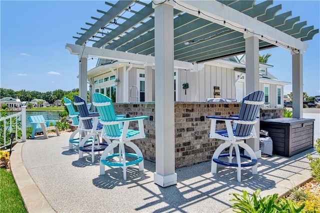 view of patio featuring a pergola and an outdoor bar