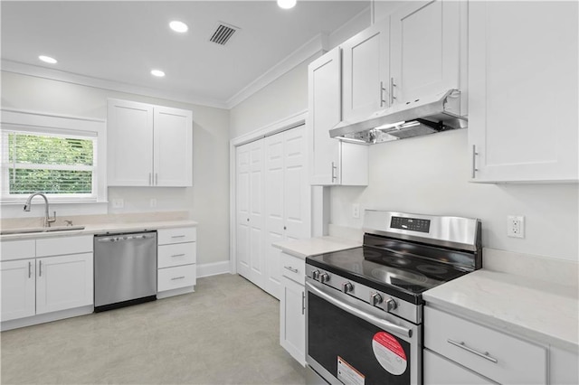 2203 Dauphin St, Mobile, AL 36606 - kitchen with stainless steel appliances, a sink, under cabinet range hood, ornamental molding, and white cabinetry