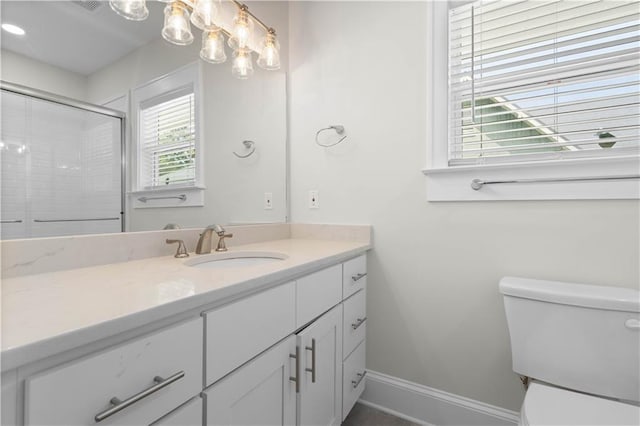2203 Dauphin St, Mobile, AL 36606 - bathroom featuring toilet, baseboards, vanity, and an enclosed shower