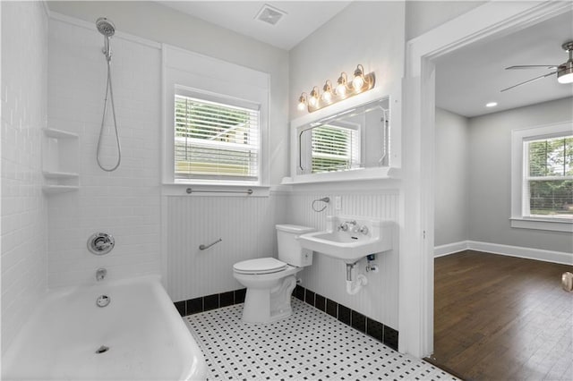 2203 Dauphin St, Mobile, AL 36606 - full bath featuring toilet, a ceiling fan,  shower combination, and wainscoting