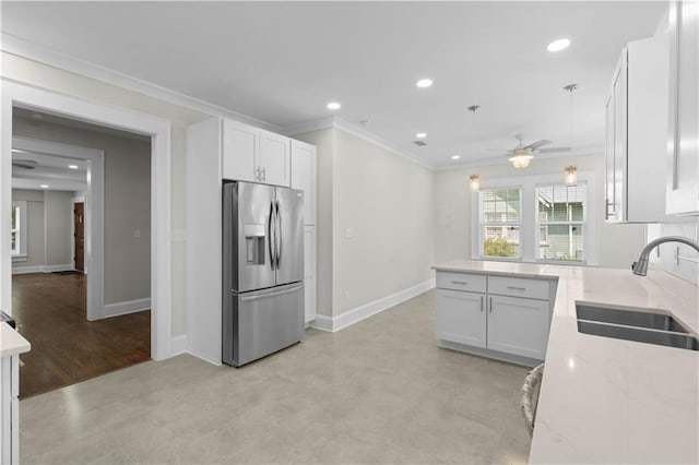 2203 Dauphin St, Mobile, AL 36606 - kitchen with stainless steel fridge with ice dispenser, a sink, crown molding, pendant lighting, and baseboards