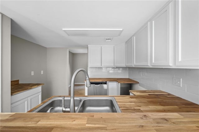 kitchen featuring white cabinetry, light wood-type flooring, backsplash, and butcher block countertops