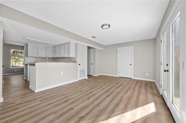 unfurnished living room featuring light wood-type flooring