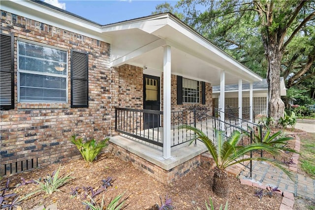 view of exterior entry with covered porch