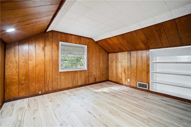 bonus room with wooden walls, vaulted ceiling, wood ceiling, and light hardwood / wood-style floors