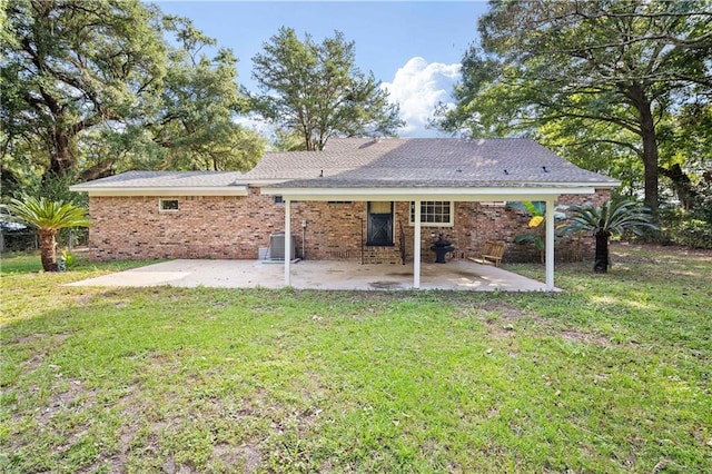 rear view of house with a patio, central air condition unit, and a lawn