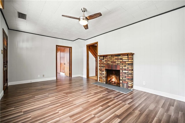 unfurnished living room with a fireplace, wood-type flooring, and ceiling fan