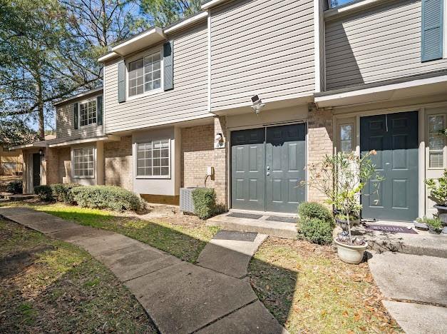 doorway to property with brick siding