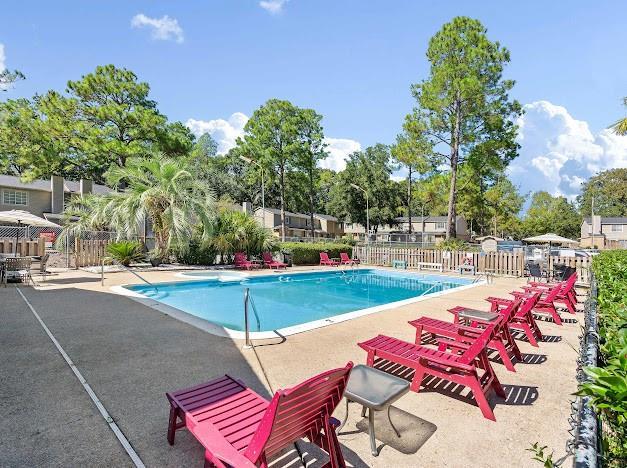 pool featuring fence and a patio