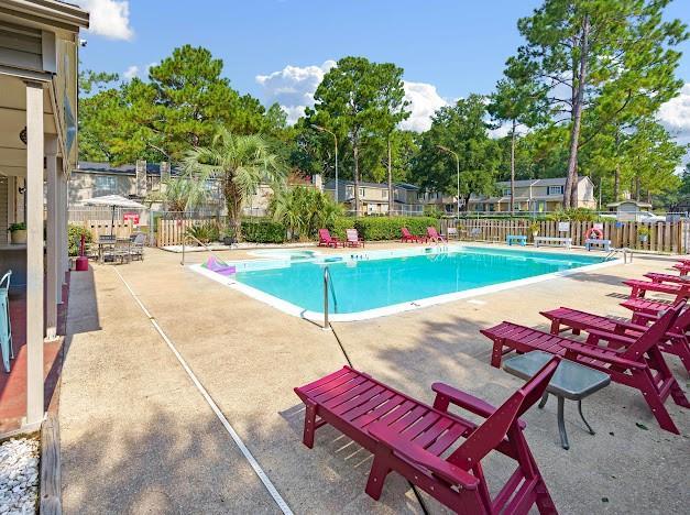 pool featuring a patio area and fence