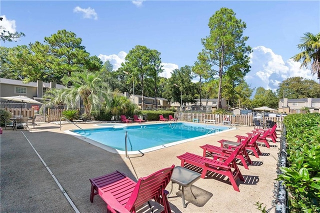 pool with fence and a patio