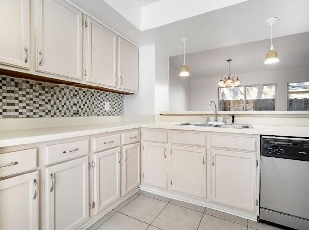 kitchen featuring light tile patterned floors, tasteful backsplash, light countertops, stainless steel dishwasher, and a sink