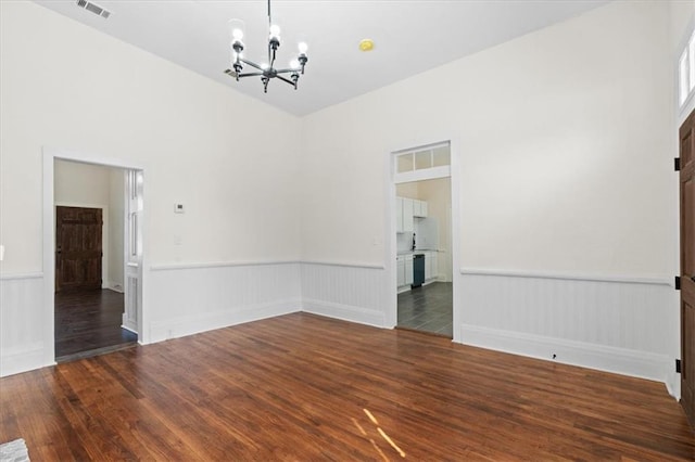 1012 Texas St, Mobile, AL 36604 - unfurnished room with dark wood-style floors, visible vents, a notable chandelier, and wainscoting