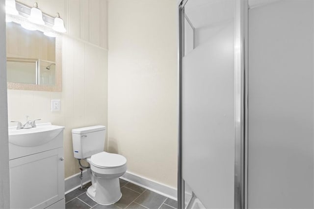 1012 Texas St, Mobile, AL 36604 - bathroom featuring tile patterned flooring, vanity, toilet, baseboards, and a stall shower