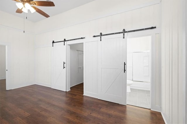 1012 Texas St, Mobile, AL 36604 - interior space with a spacious closet, ensuite bathroom, dark wood-type flooring, a barn door, and a closet