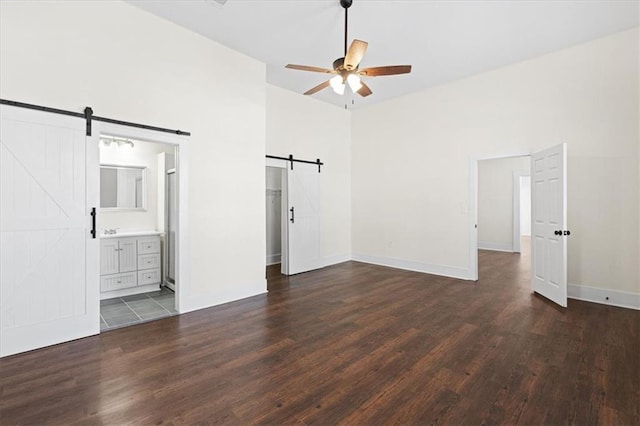 1012 Texas St, Mobile, AL 36604 - unfurnished bedroom with a barn door, high vaulted ceiling, and wood finished floors