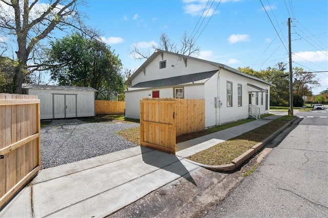 1012 Texas St, Mobile, AL 36604 - view of side of home featuring an outbuilding, fence, and a storage unit