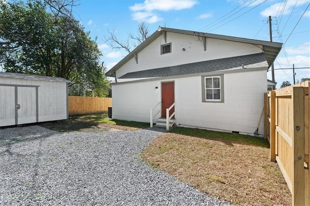 1012 Texas St, Mobile, AL 36604 - rear view of house with a fenced backyard, crawl space, entry steps, and an outdoor structure