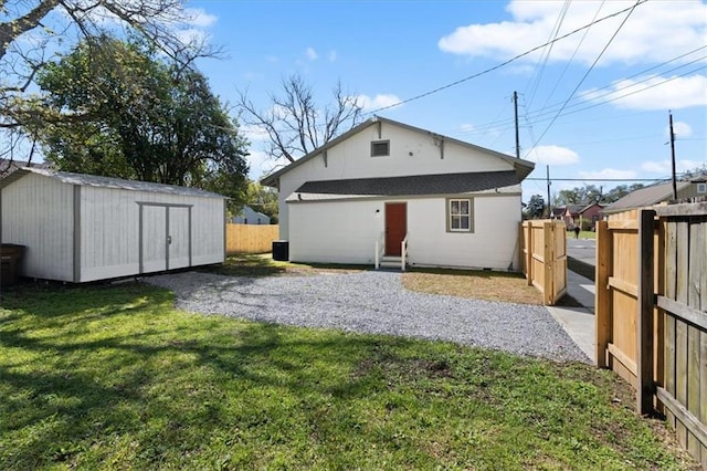 1012 Texas St, Mobile, AL 36604 - back of house with a fenced backyard, an outdoor structure, and a yard