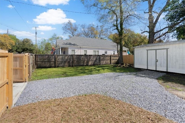 1012 Texas St, Mobile, AL 36604 - view of yard featuring a fenced backyard, a storage unit, and an outbuilding