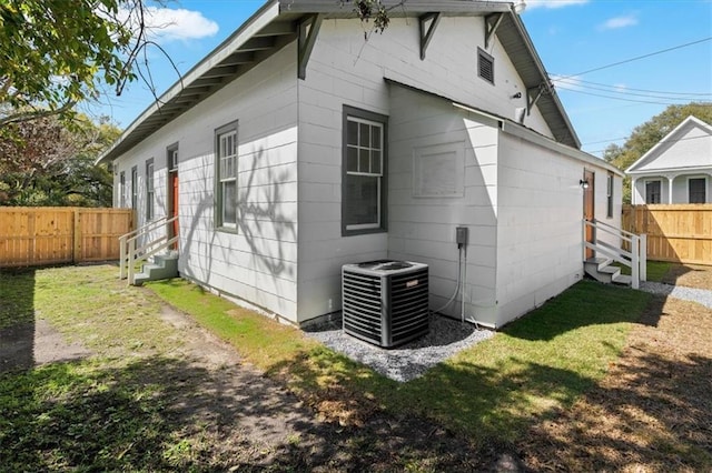 1012 Texas St, Mobile, AL 36604 - view of home's exterior featuring a lawn, fence, central AC, and entry steps