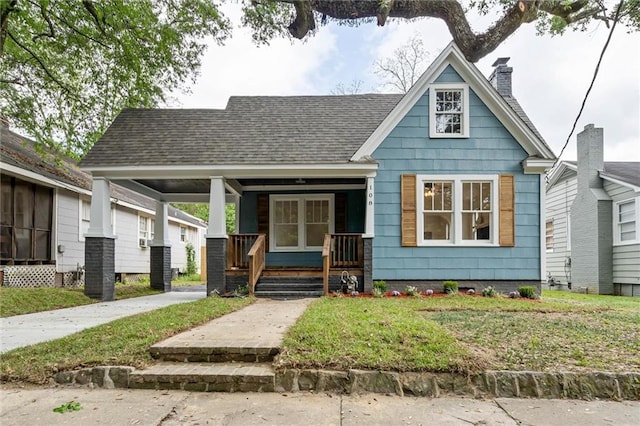 108 Crenshaw St, Mobile, AL 36606 - bungalow-style home with a chimney, covered porch, and roof with shingles