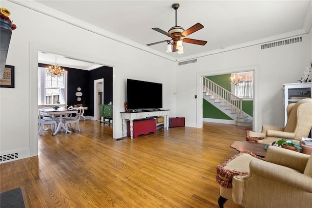 264 Mcdonald Ave, Mobile, AL 36604 - living area with a chandelier, wood finished floors, a ceiling fan, and crown molding