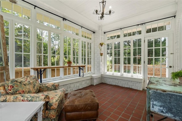 264 Mcdonald Ave, Mobile, AL 36604 - unfurnished sunroom featuring tile patterned flooring, healthy amount of natural light, and a chandelier