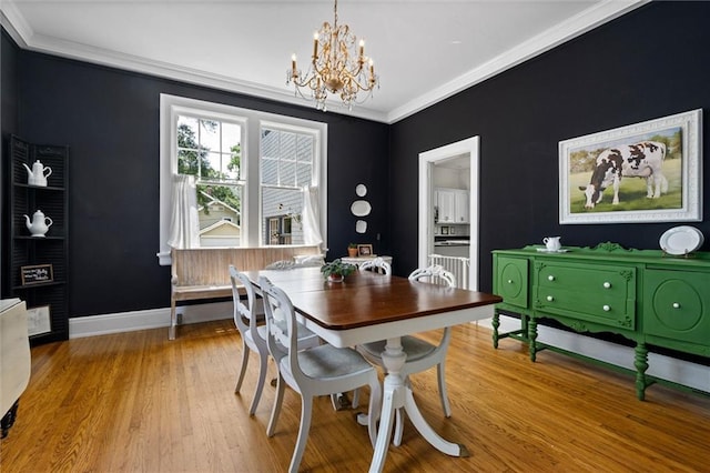 264 Mcdonald Ave, Mobile, AL 36604 - dining room featuring a chandelier, crown molding, and wood finished floors