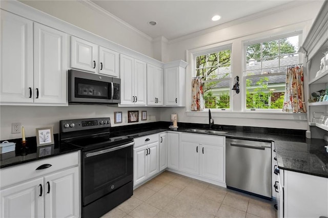 264 Mcdonald Ave, Mobile, AL 36604 - kitchen with stainless steel appliances, white cabinets, ornamental molding, recessed lighting, and light tile patterned floors
