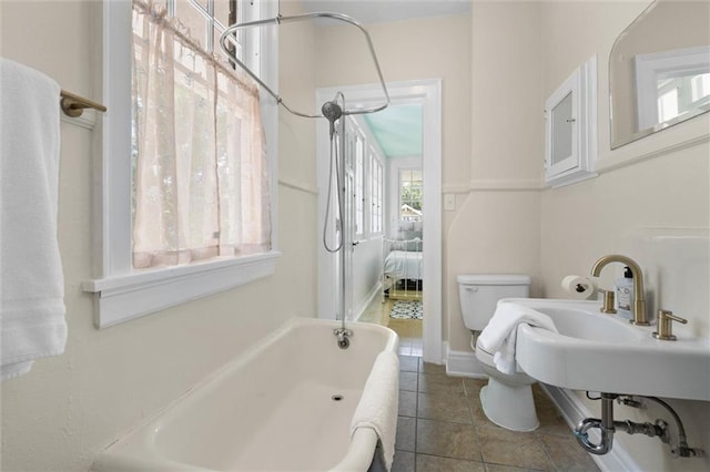 264 Mcdonald Ave, Mobile, AL 36604 - ensuite bathroom with a tub and tile patterned flooring