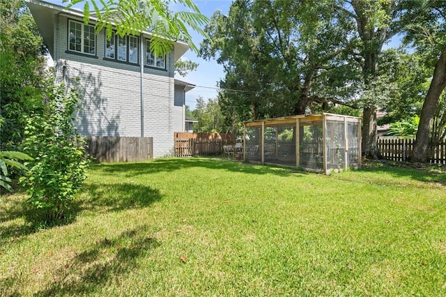 264 Mcdonald Ave, Mobile, AL 36604 - fenced backyard featuring exterior structure and an outbuilding
