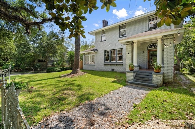 264 Mcdonald Ave, Mobile, AL 36604 - view of front of house with brick siding, a chimney, and a front yard
