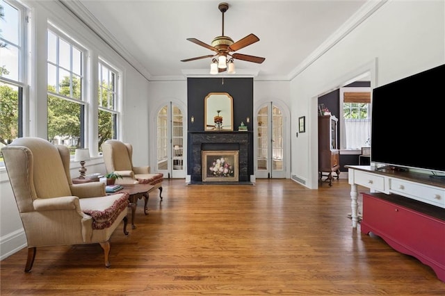 264 Mcdonald Ave, Mobile, AL 36604 - living area featuring ornamental molding, a fireplace with flush hearth, plenty of natural light, and wood finished floors