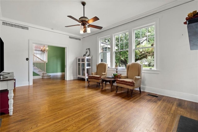 264 Mcdonald Ave, Mobile, AL 36604 - living area featuring wood finished floors, stairway, a ceiling fan, ornamental molding, and a chandelier
